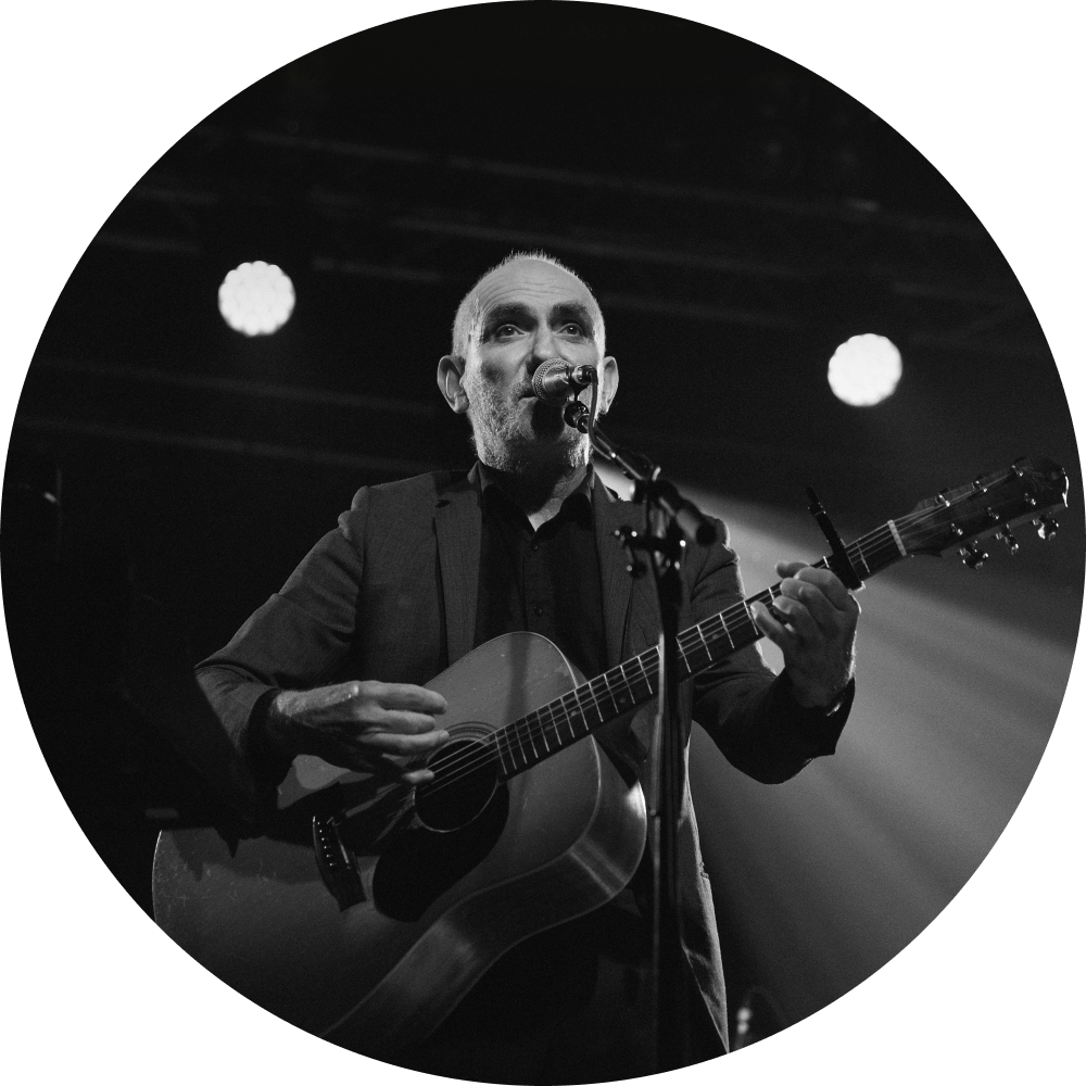 Paul Kelly playing the guitar